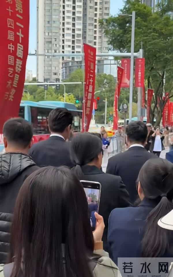 靳东重庆开会，路边走着被夸好帅，微笑招手回应，儒雅随和！