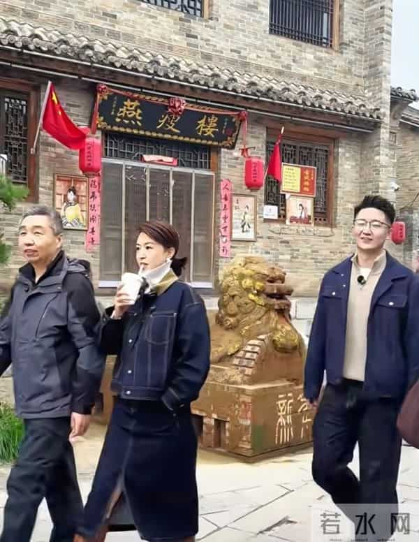 主持人张蕾边喝奶茶边走在古城街道上，46岁依旧美丽优雅！