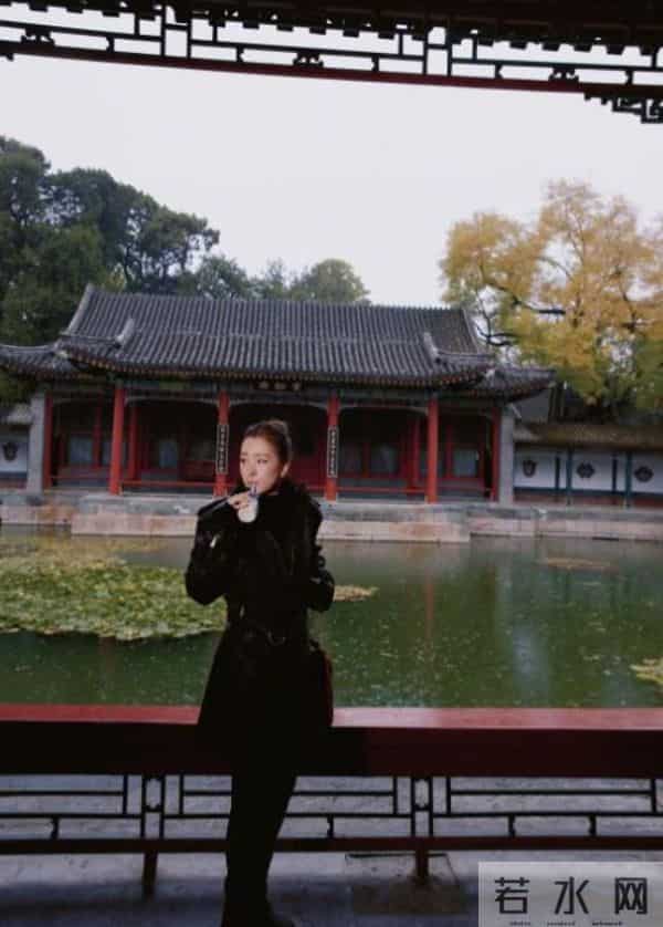 59岁巩俐现身北京公园，穿黑皮衣配透明伞，雨中喝酸奶吃冰糖葫芦