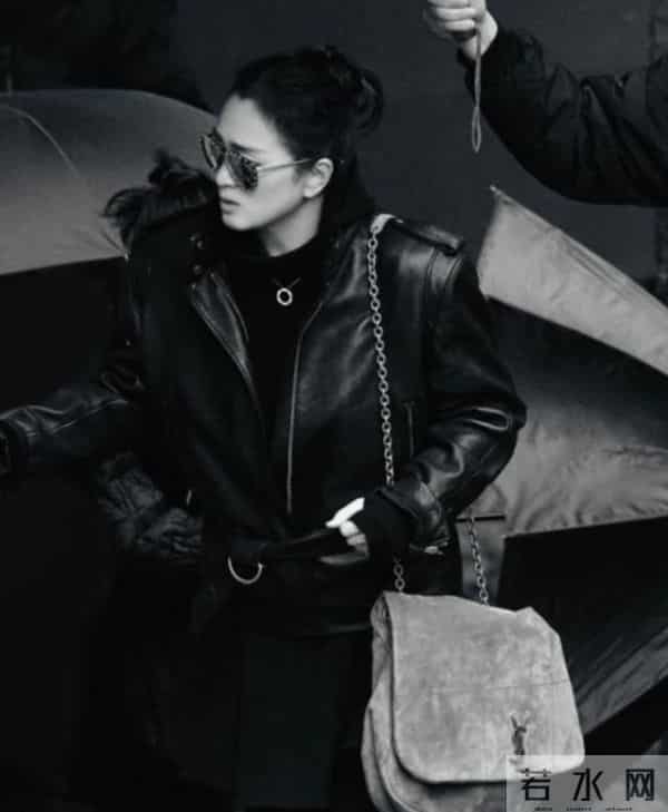 59岁巩俐现身北京公园，穿黑皮衣配透明伞，雨中喝酸奶吃冰糖葫芦